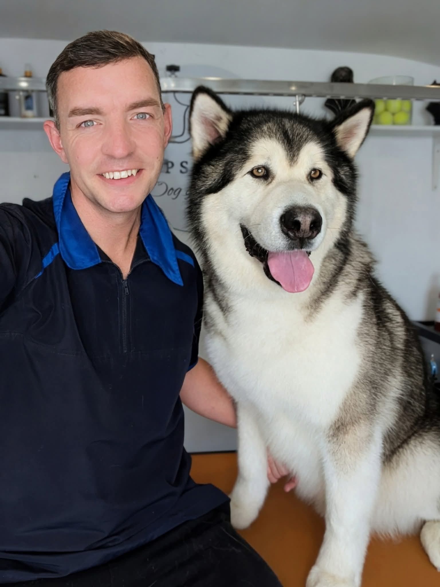 Chris Mapstone with a happy husky in the salon